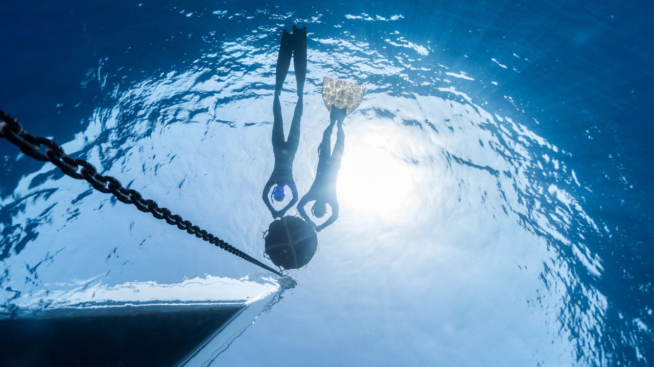 Freedivers exploring reef gullies