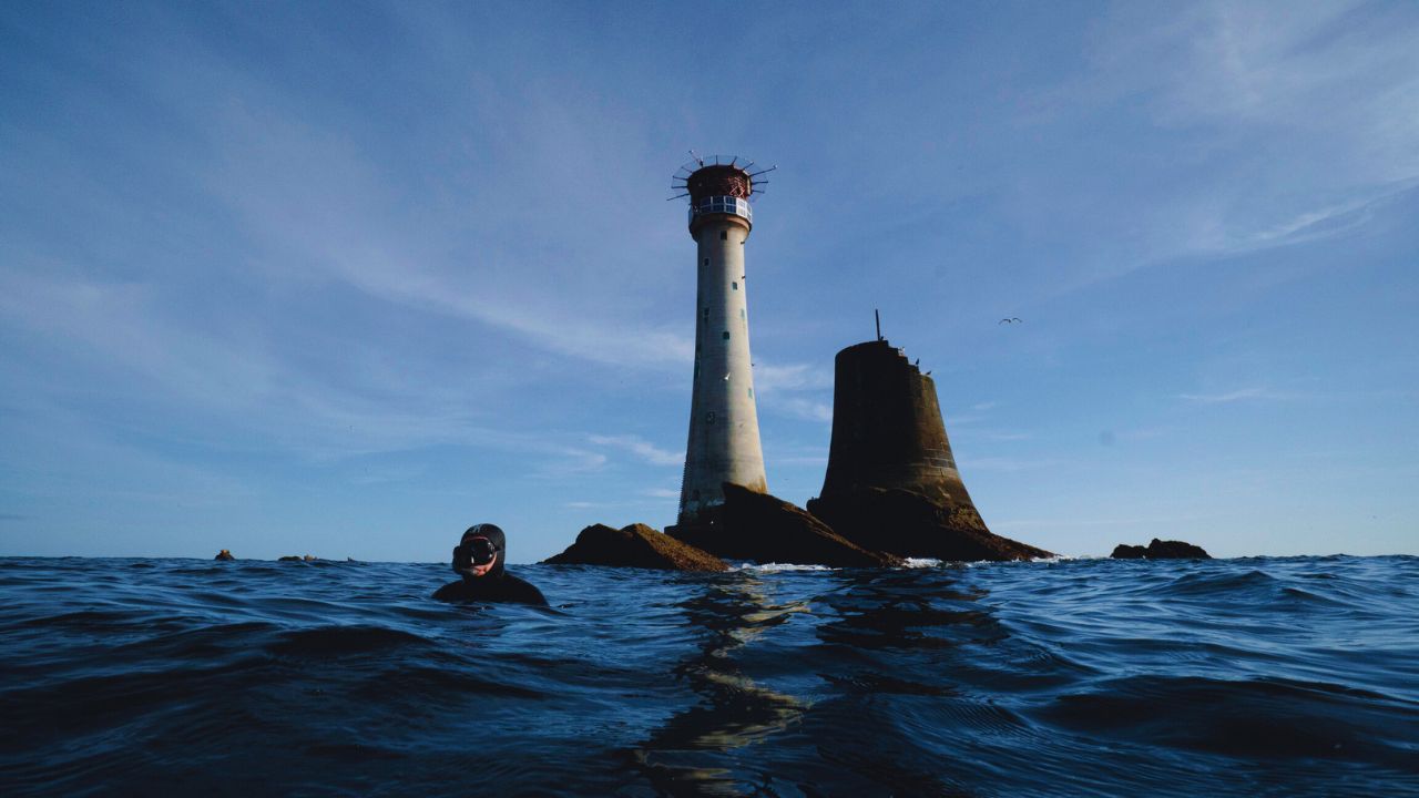 Offshore lighthouse with snorkellers at the surface